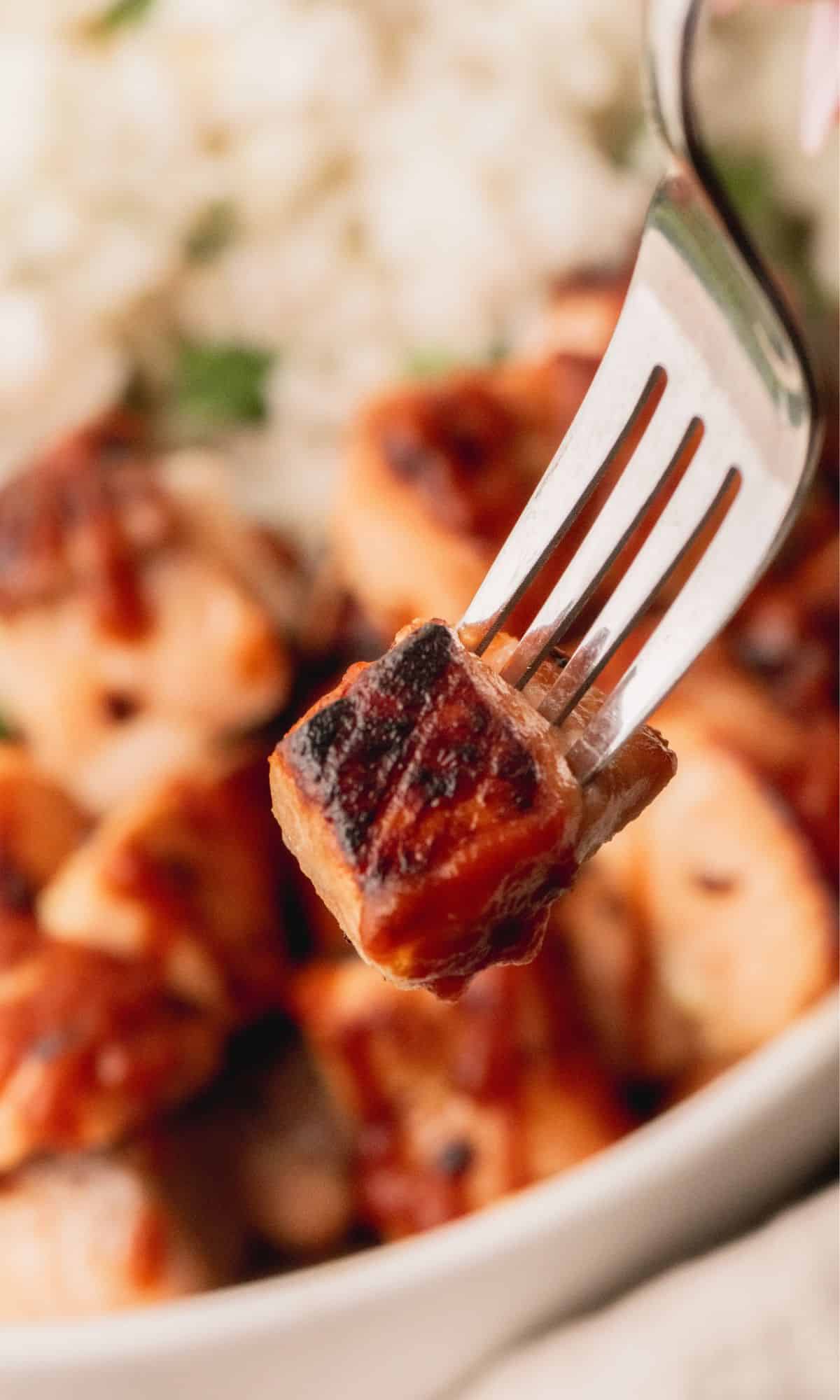 A salmon bite on a fork.