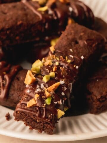 Chocolate shortbread topped with melted chocolate and pistachios.