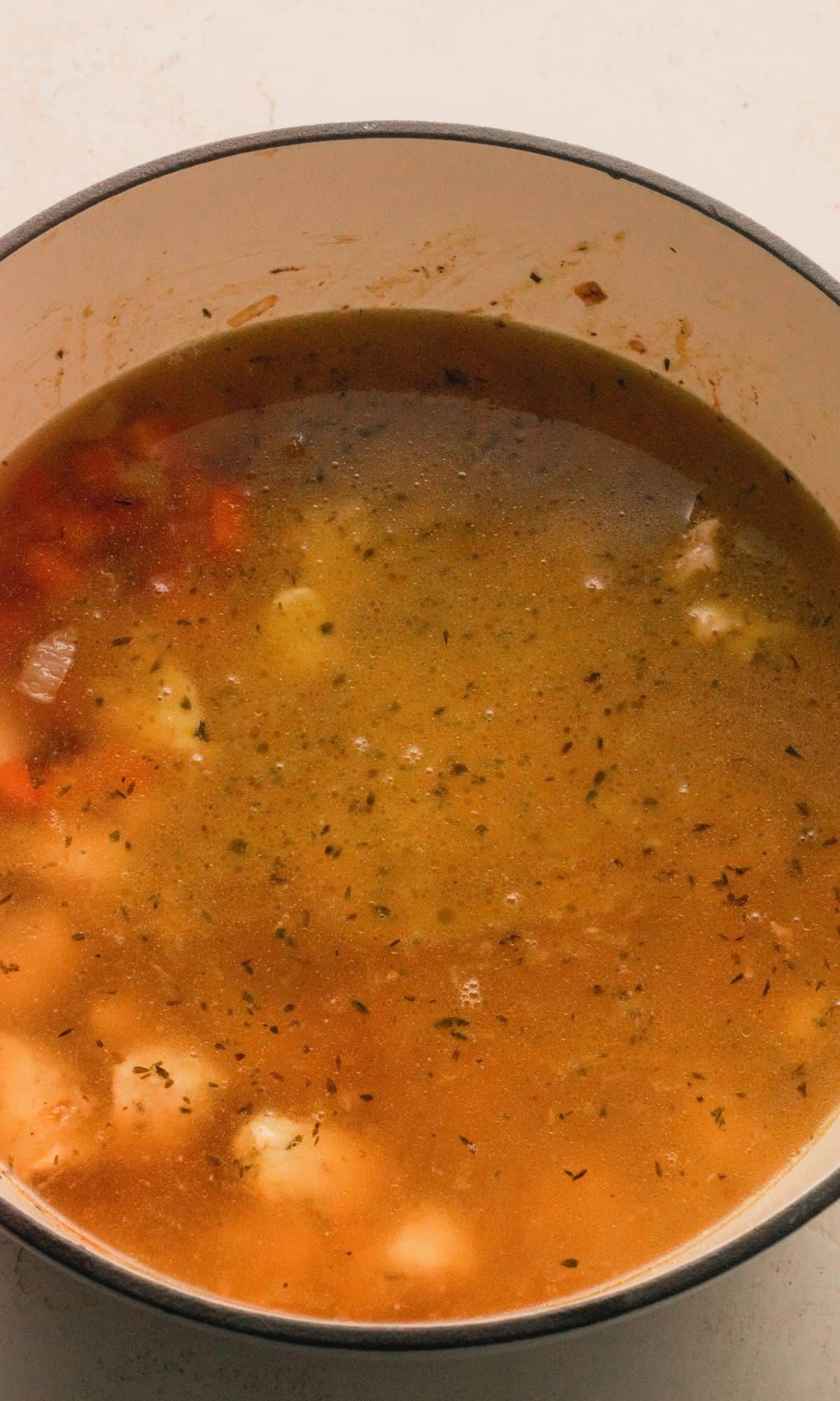 Chicken orzo soup preparation.