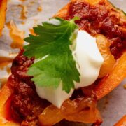 One chorizo stuffed bell pepper nacho topped with sour cream and cilantro.