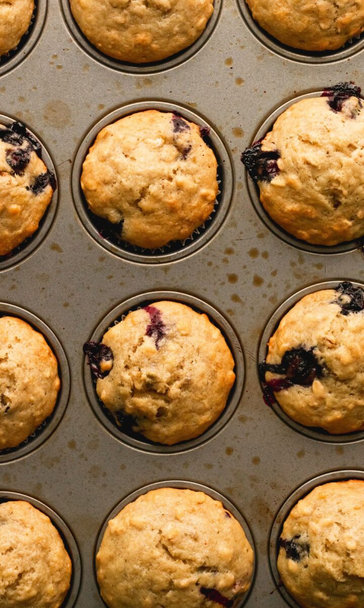 Baked blueberry banana muffins in muffin tin.