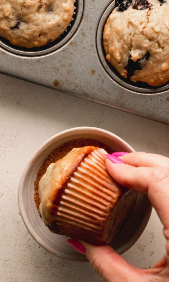 Dipping muffin tops in turbinado sugar.