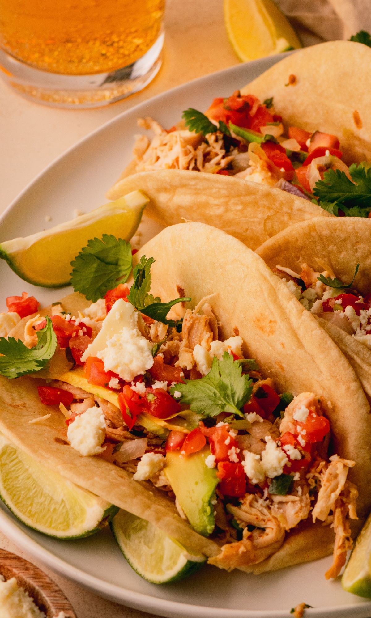 Tortillas filled with shredded chicken, pico de gallo and queso fresco.