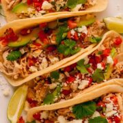 Tortillas filled with shredded chicken, pico de gallo and queso fresco.