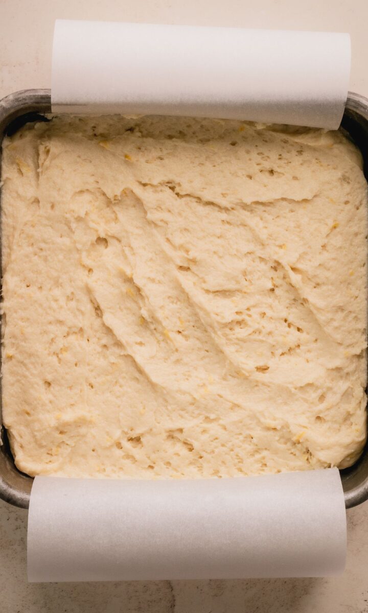 Lemon cake in a square cake pan before baking.