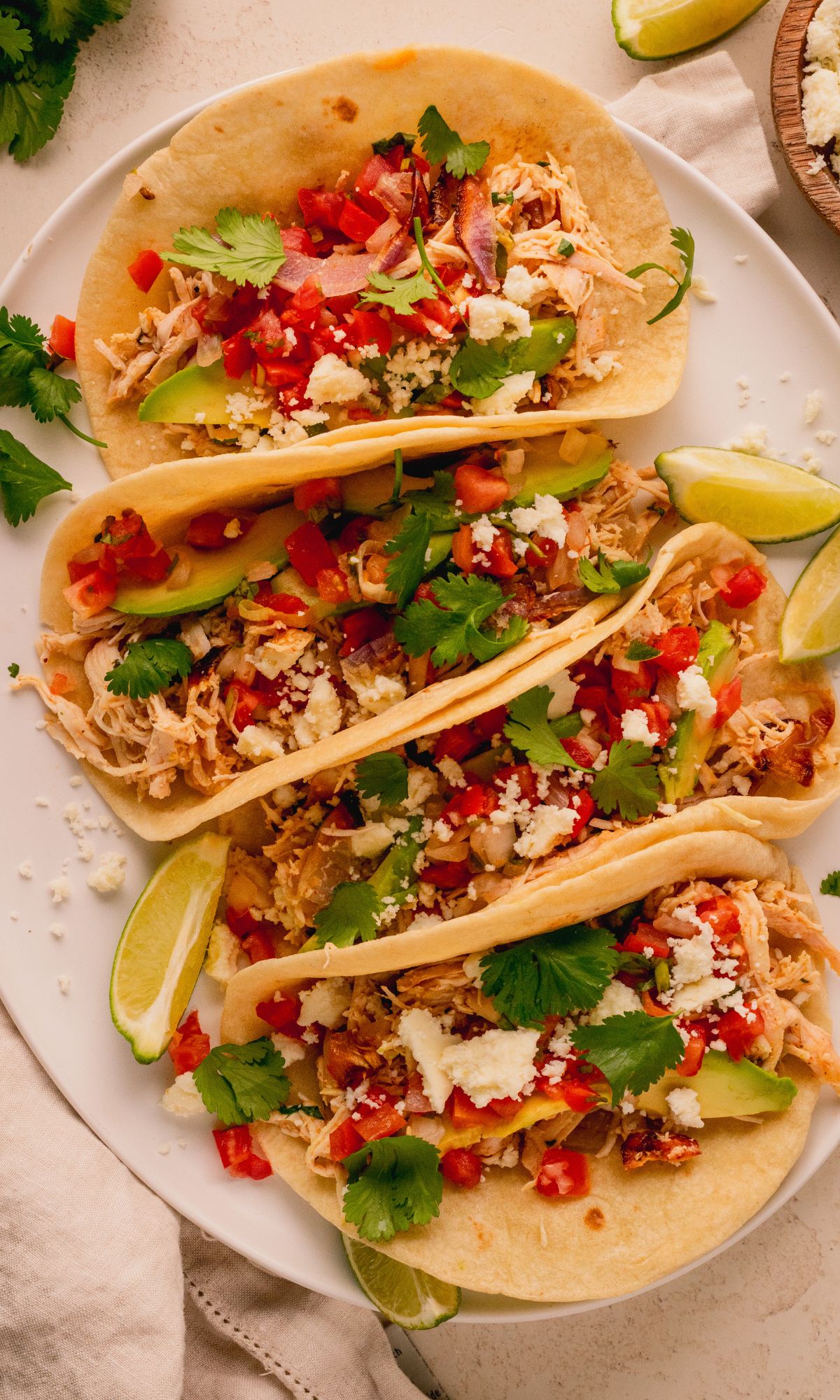 Tortillas filled with shredded chicken, pico de gallo and queso fresco.