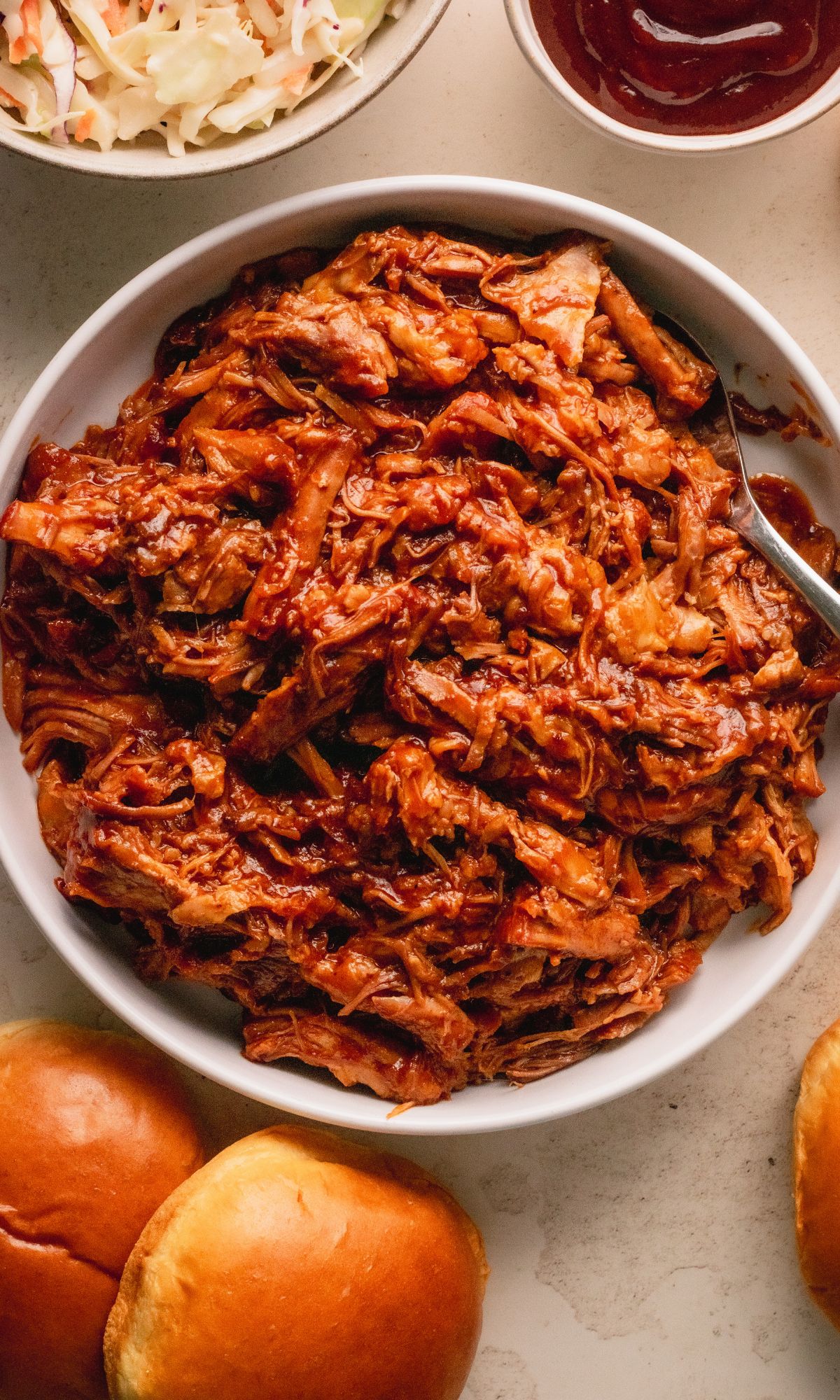 Pulled pork in a white bowl.