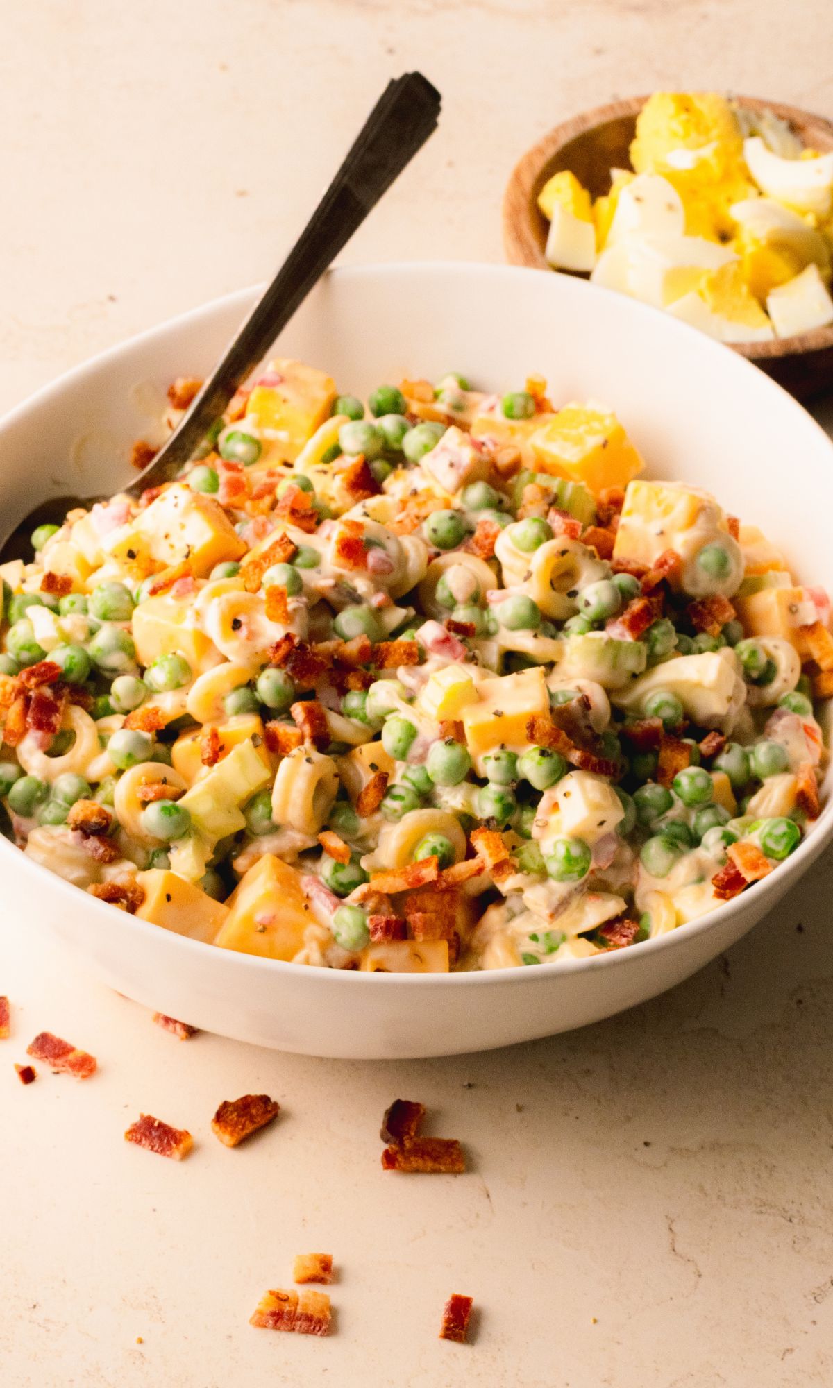 Pasta salad in a white bowl.