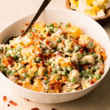 Pasta salad in a white bowl.
