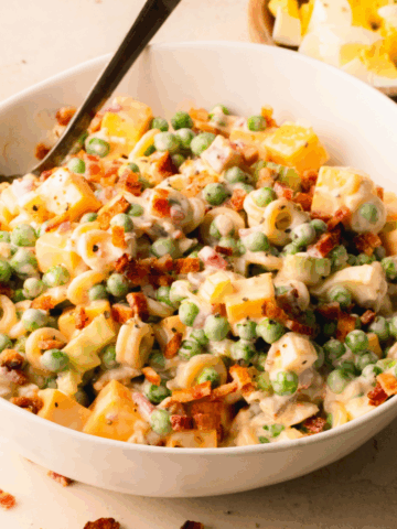 Pasta salad in a white bowl.