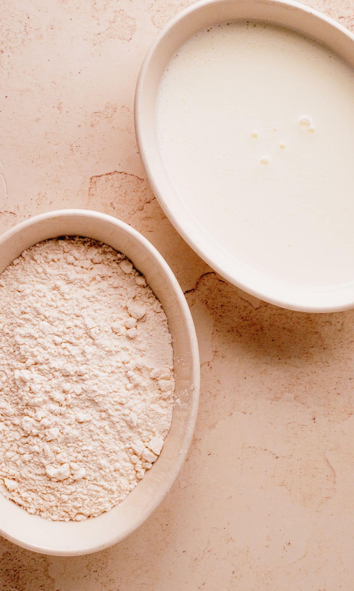Two shallow bowls with flour and buttermilk.