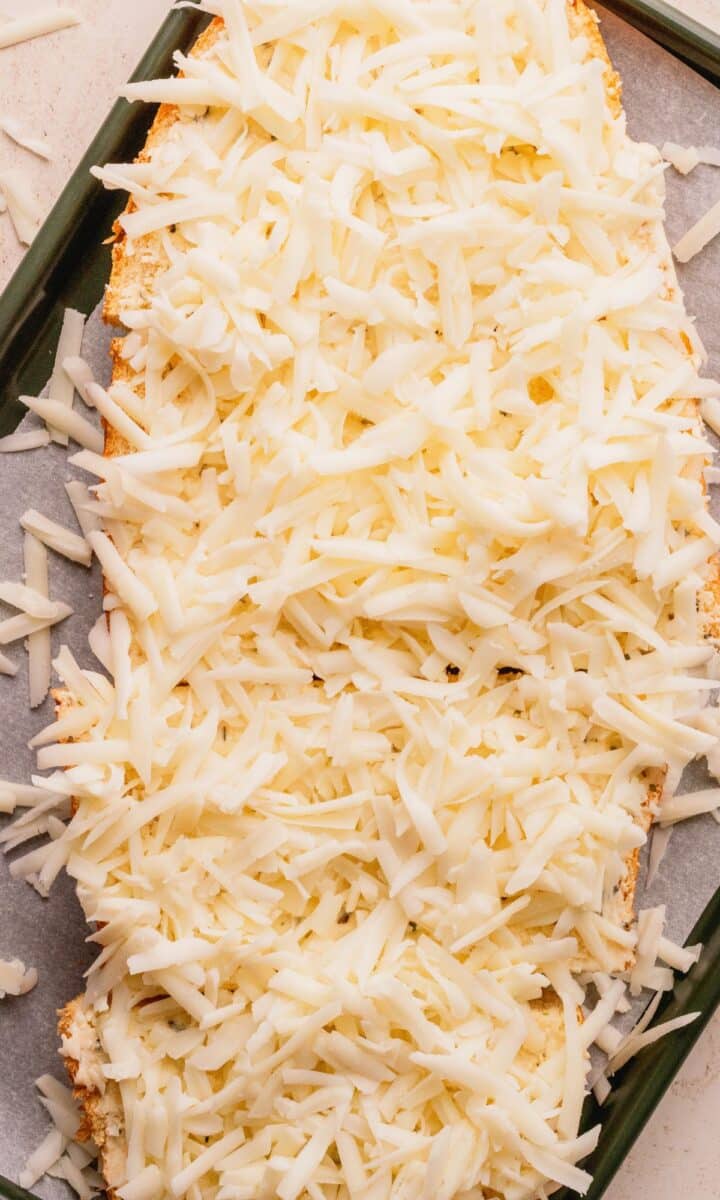 Bread topped with shredded cheese.
