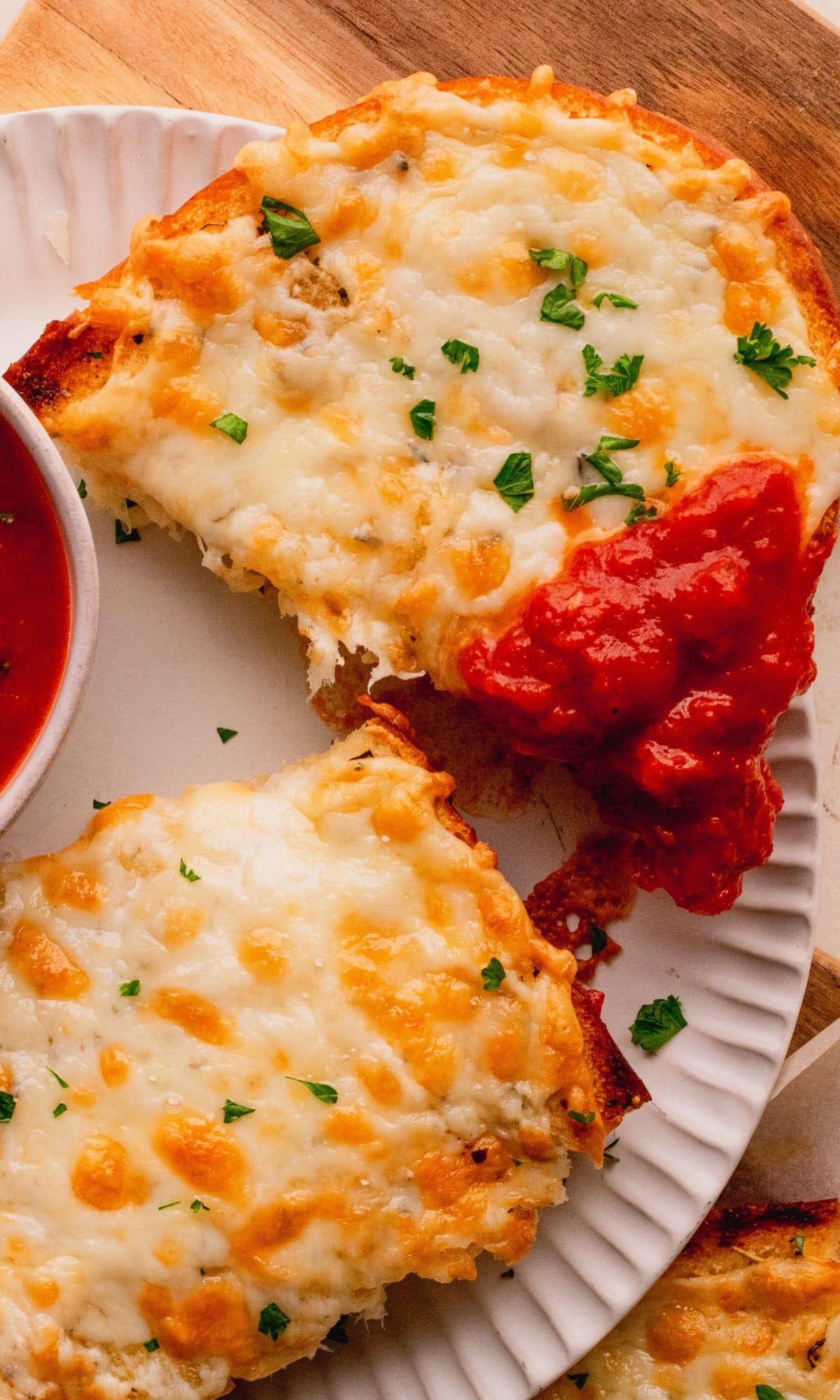 A cheesy piece of bread dipped in marinara sauce.
