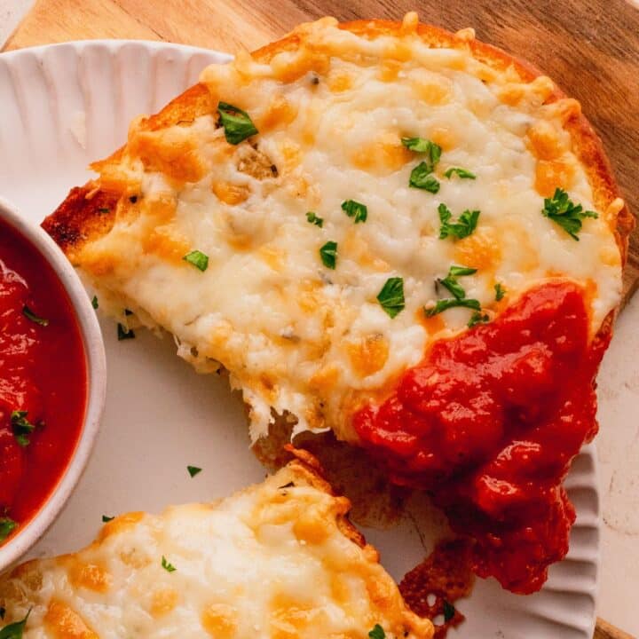 Cheesy topped bread dipped in marinara.