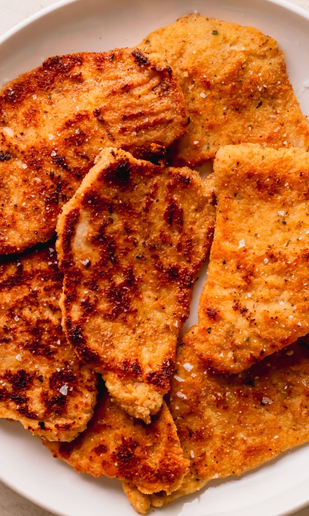 Crispy pork chops on a plate.