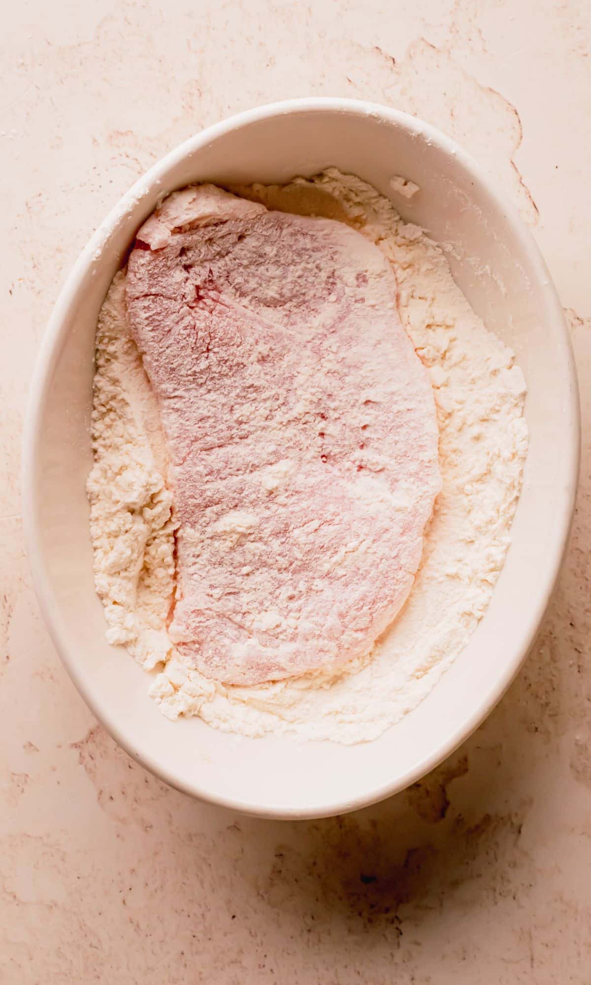 A pork chop dredged in flour.