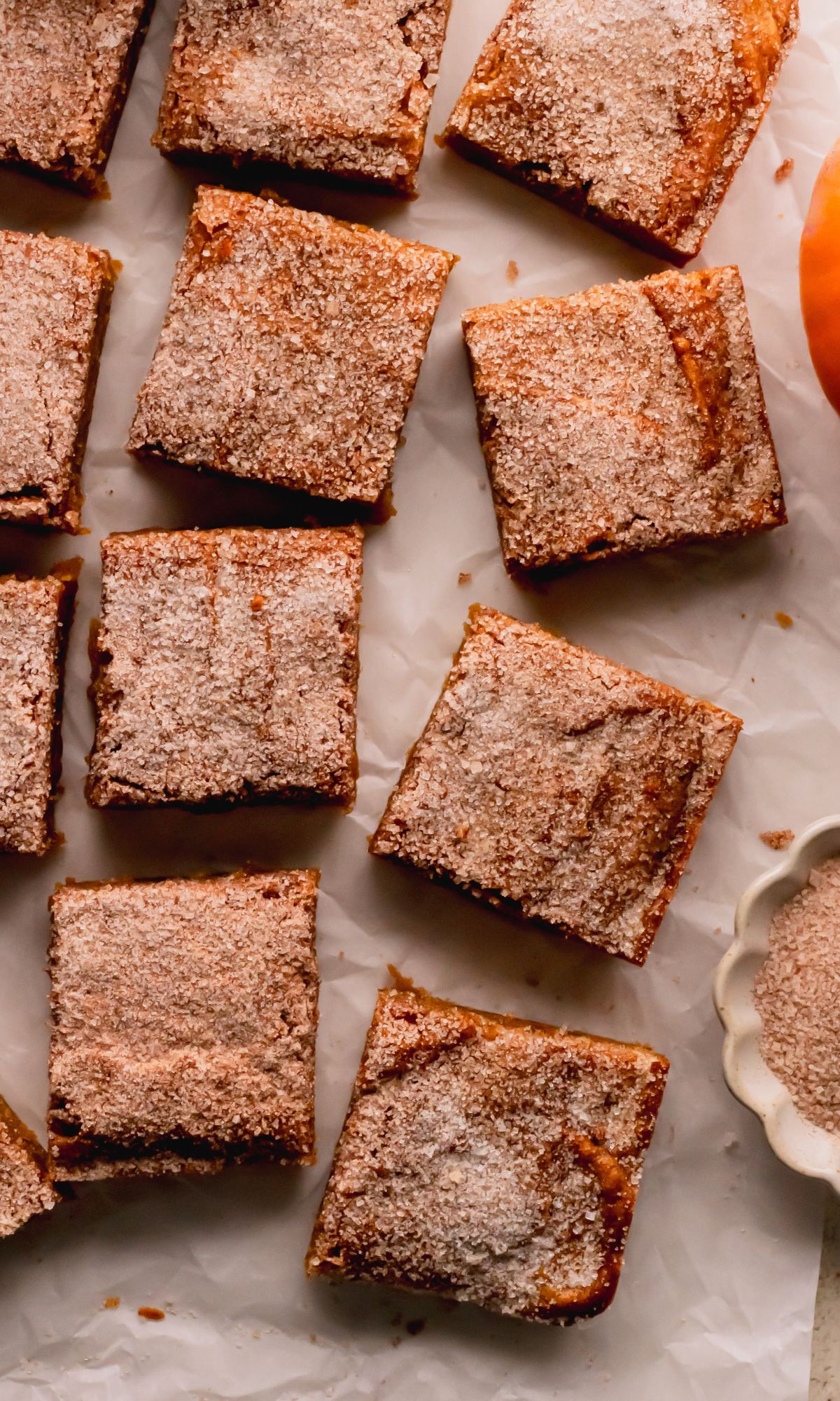 Pumpkin blondies with a cinnamon sugar top cut into squares.