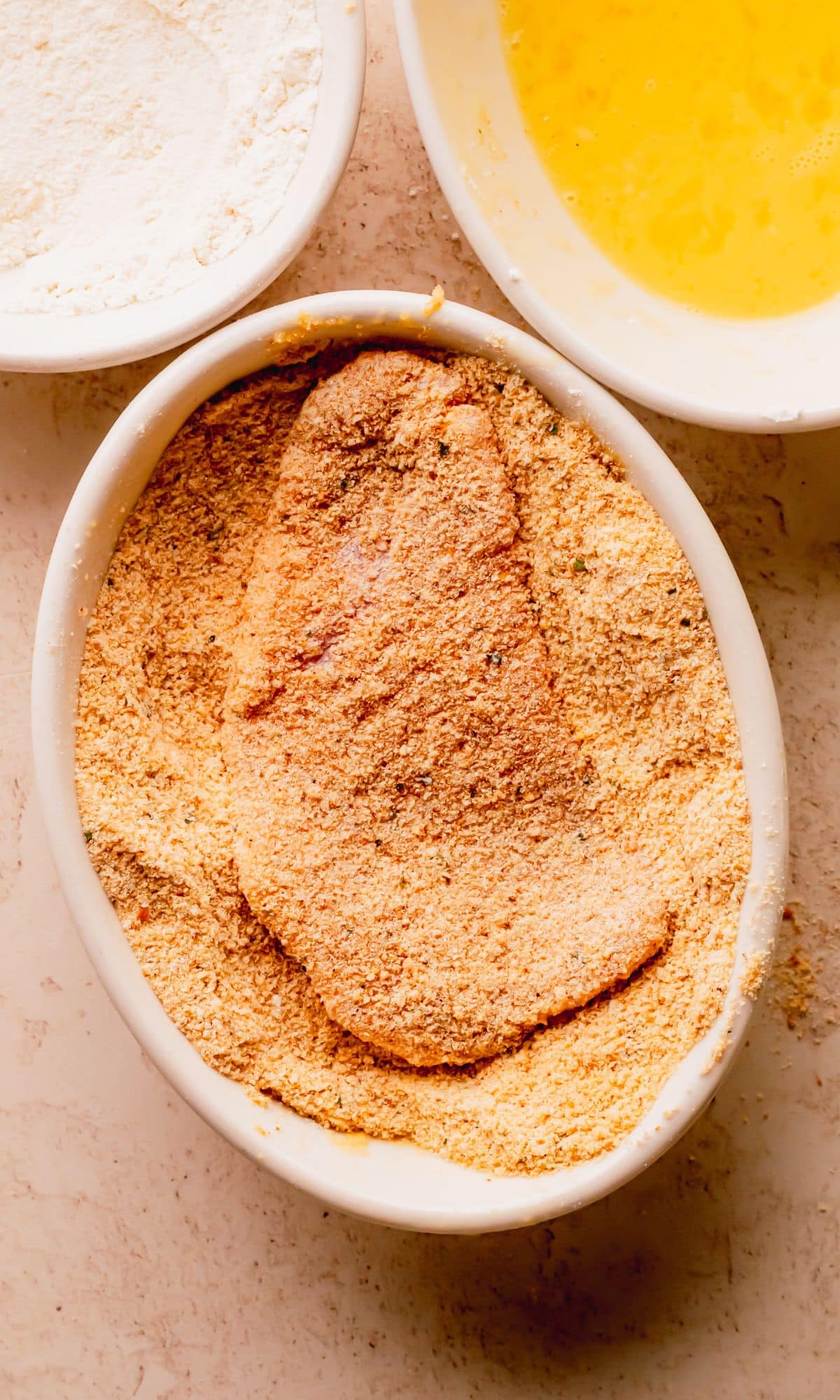 A pork chop dredged in breadcrumbs.