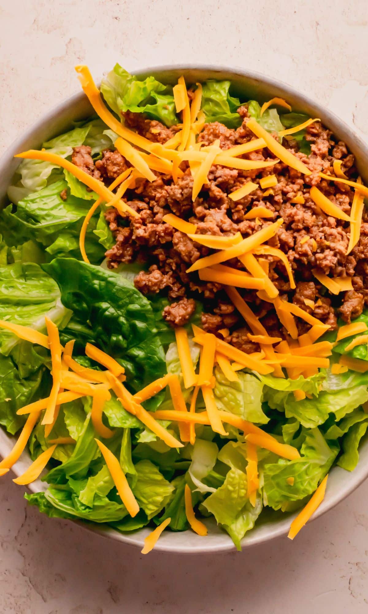 Cheeseburger salad preparation.