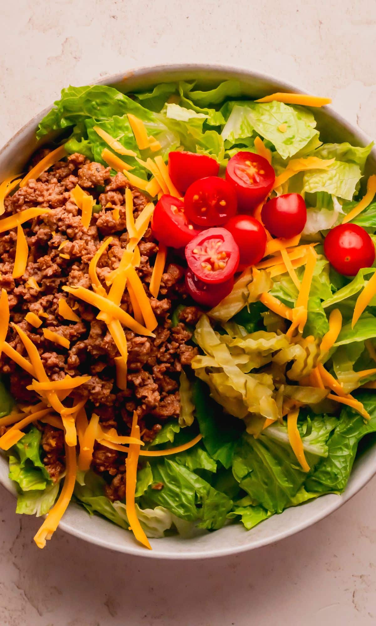 Cheeseburger salad preparation.