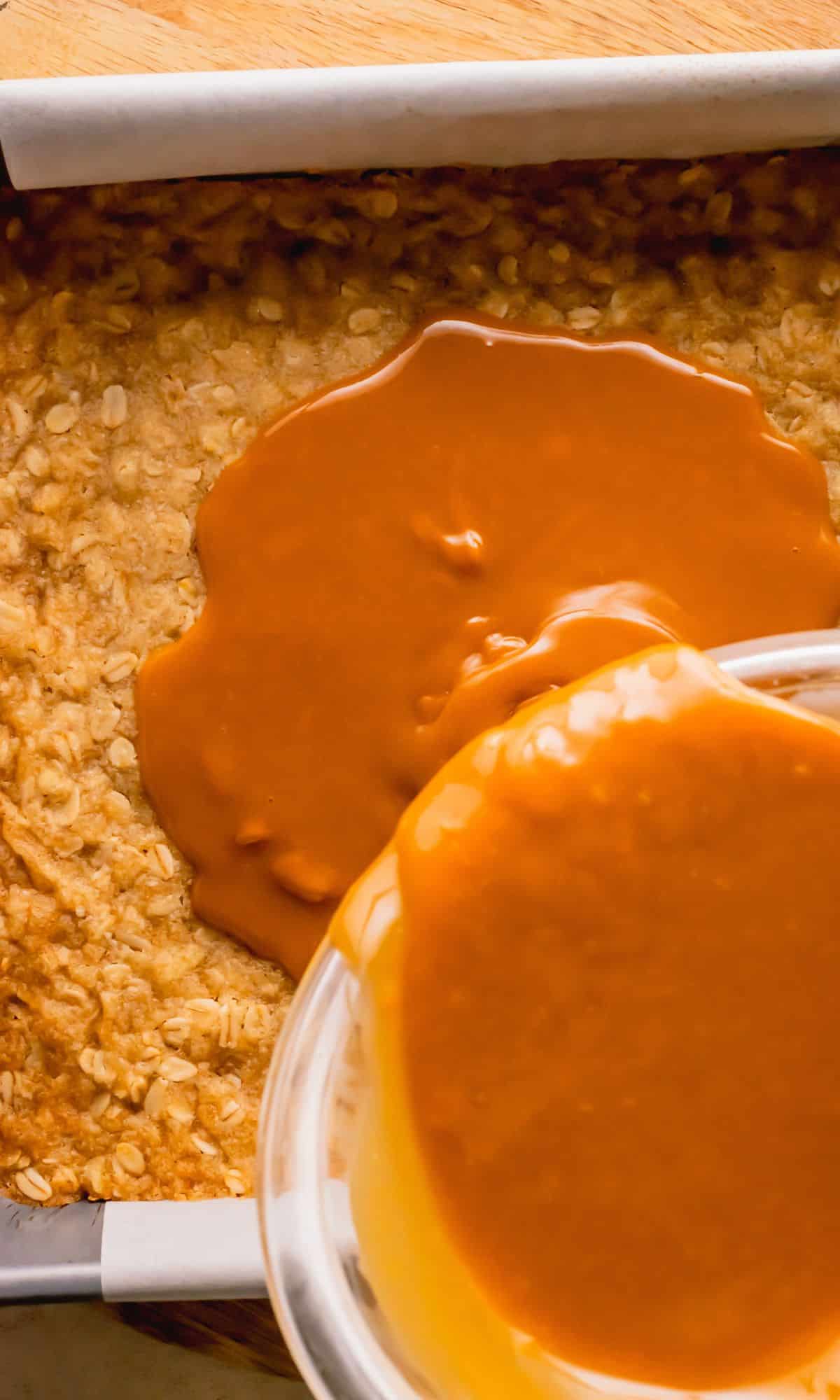 Pour caramel over oat layer in pan.