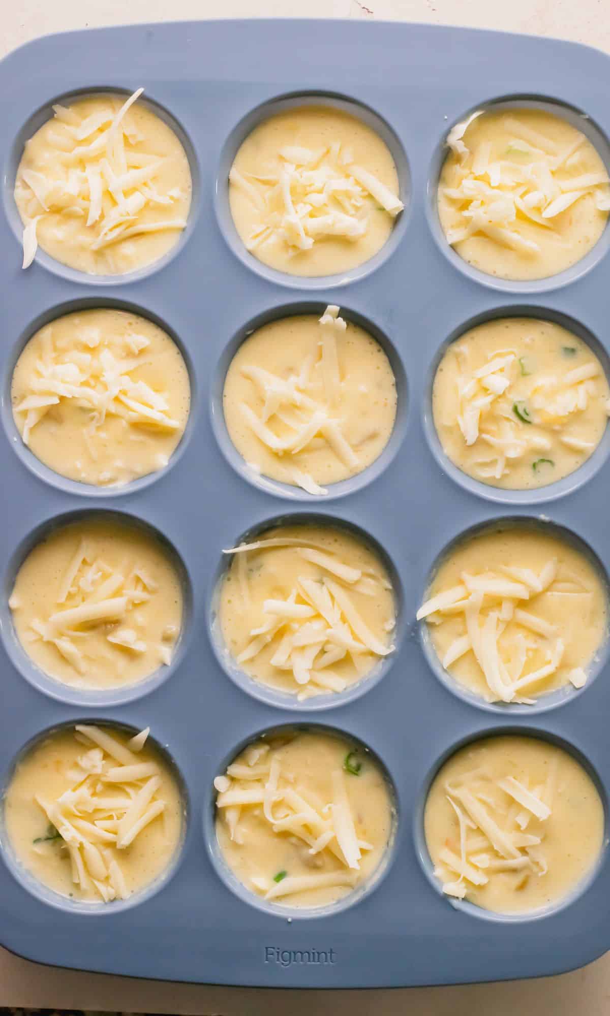 Egg bites in muffin tin before baking.