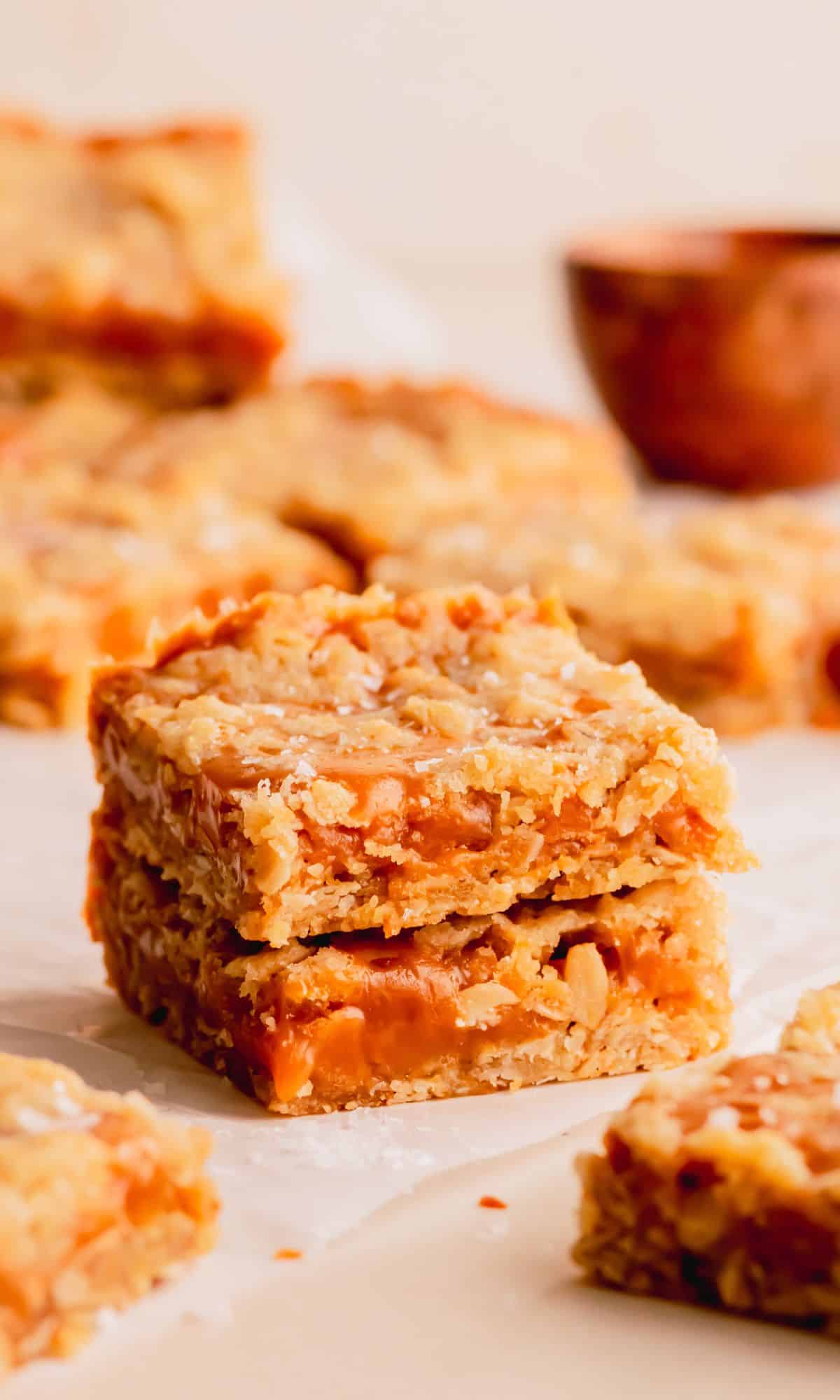 Two caramel oat bars stacked on top of one another.