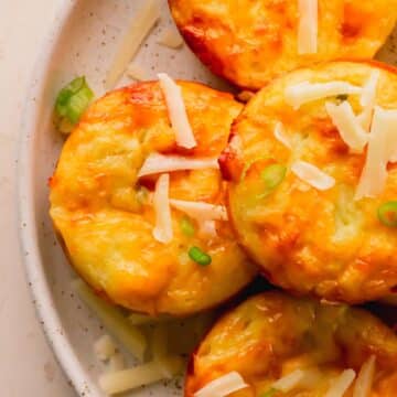 Egg bites stacked on a plate.