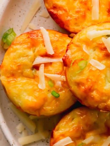 Egg bites stacked on a plate.