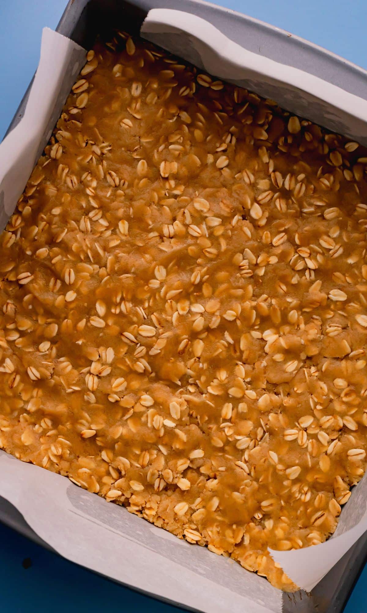 Oat mixture spread in the bottom of a square pan.