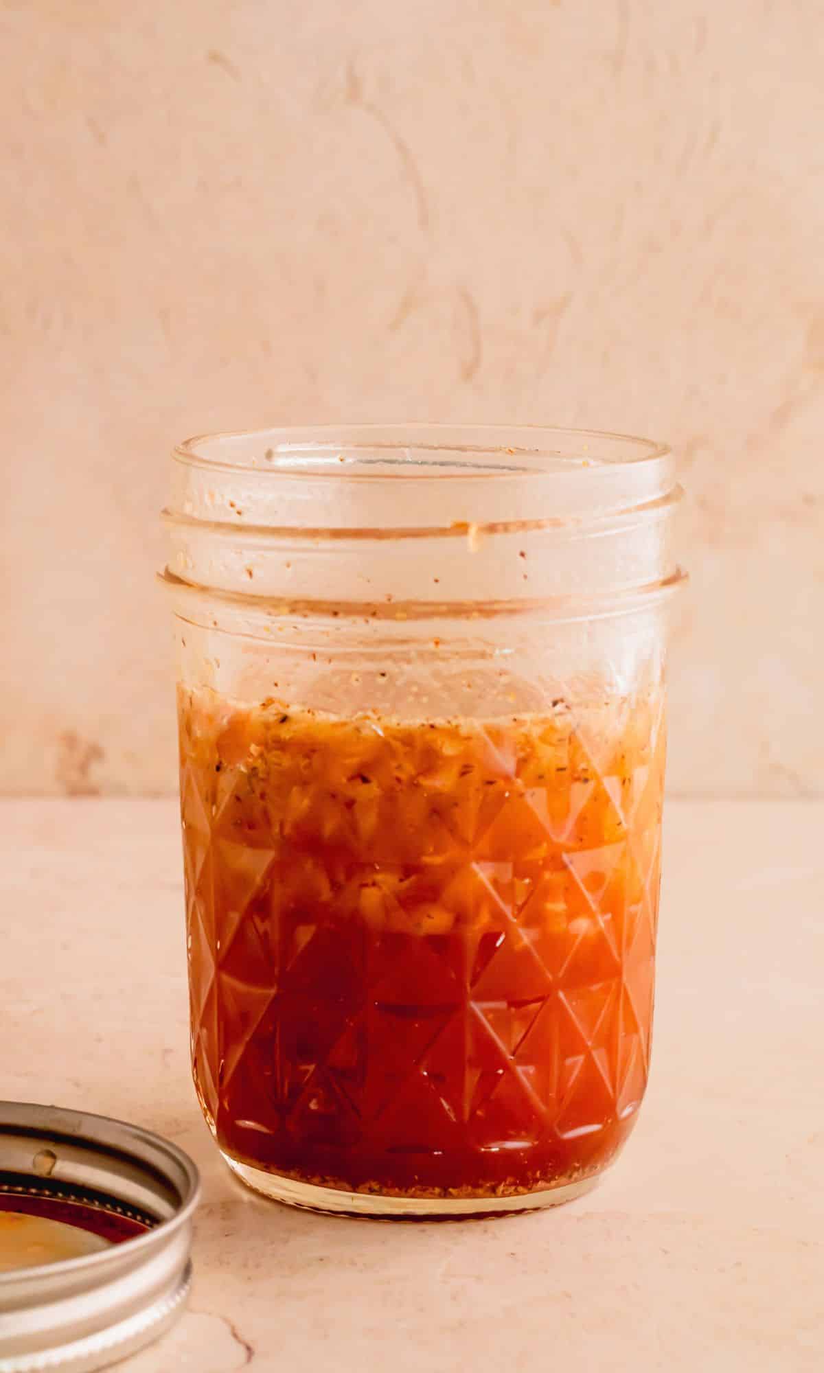 Walnut vinaigrette ingredients in a glass jar.