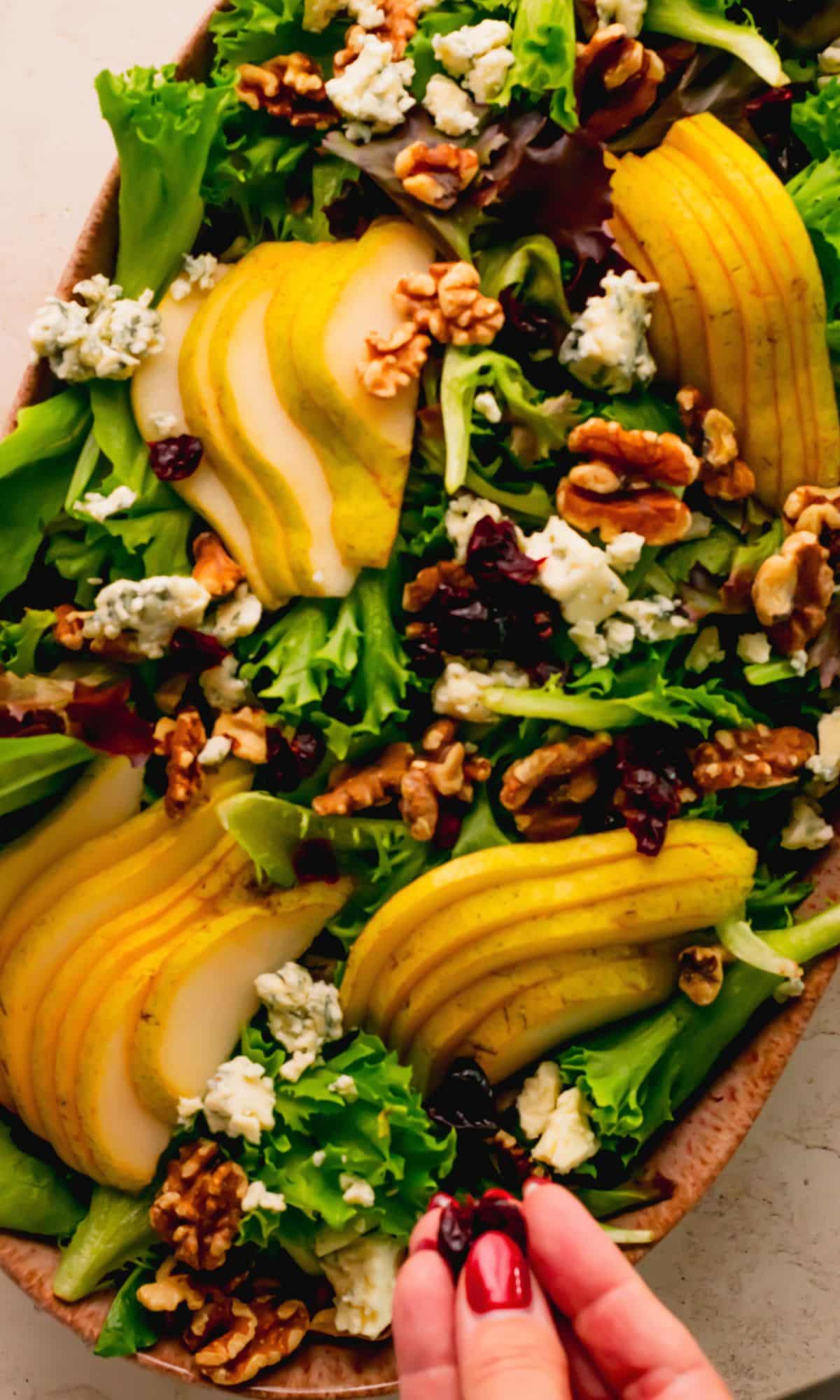 Assembling pear blue cheese salad.